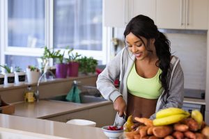 Black Women cutting fruit after IV boost treatment